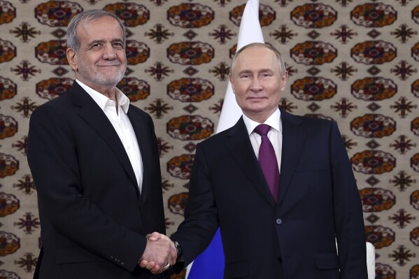 FILE - Russian President Vladimir Putin, right, and Iranian President Masoud Pezeshkian pose for a photo at their meeting in Ashgabat, Turkmenistan, on Oct. 11, 2024. (Alexander Shcherbak, Sputnik, Kremlin Pool Photo via AP, File)