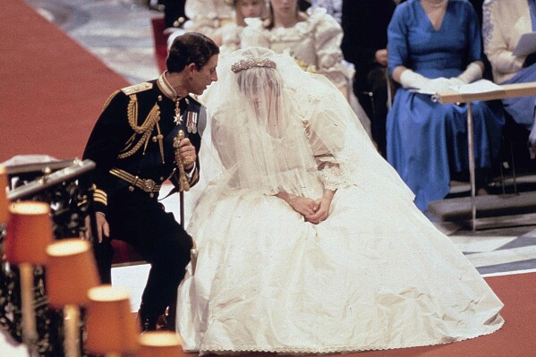 FILE - Britain's Prince Charles speaks with his bride Princess Diana, during their wedding ceremony in St. Paul's Cathedral, London, July 29, 1981. (AP Photo/File)