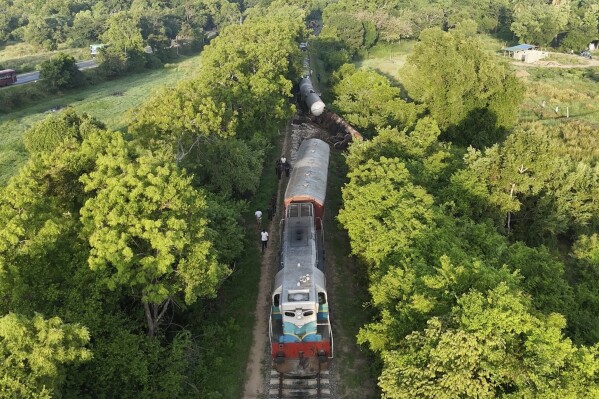 This image made from a video footage shows a derailed fuel transporting train in Minneriya, Sri Lanka, Saturday, Oct. 19, 2024, after it collided with a heard of elephants Friday. (AP Photo)