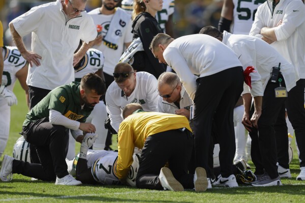 Green Bay Packers linebacker Quay Walker (7) is evaluated after a play during the first half of an NFL football game against the Houston Texans, Sunday, Oct. 20, 2024, in Green Bay, Wis. (AP Photo/Matt Ludtke)