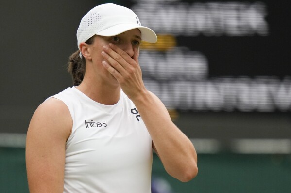 Iga Swiatek of Poland reacts during her third round loss to Yulia Putintseva of Kazakhstan at the Wimbledon tennis championships in London, Saturday, July 6, 2024. (AP Photo/Alberto Pezzali)