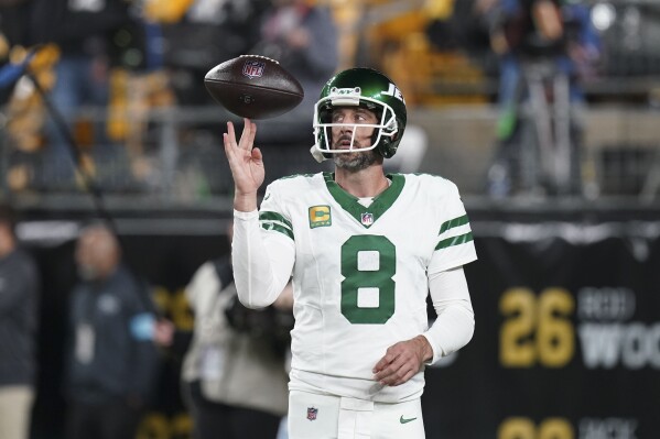 New York Jets quarterback Aaron Rodgers (8) warms up before an NFL football game against the Pittsburgh Steelers in Pittsburgh, Sunday, Oct. 20, 2024. (AP Photo/Matt Freed)