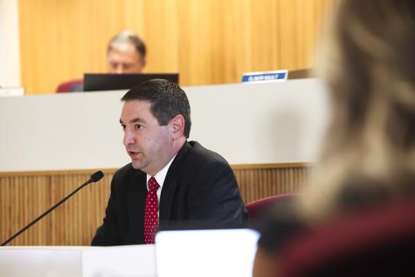 Montana Attorney General Austin Knudsen testifies in his own professional misconduct trial before the Commission on Practice in the Montana Supreme Court Chambers on Wednesday, Oct. 9, 2024, in Helena, Mont. (Thom Bridge/Independent Record via AP)