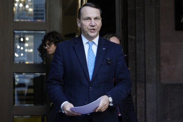 Poland's Foreign Minister Radek Sikorski speaks to the media outside the Foreign Ministry in Warsaw, Poland, Tuesday, Oct. 22, 2024. (AP Photo/Czarek Sokolowski)