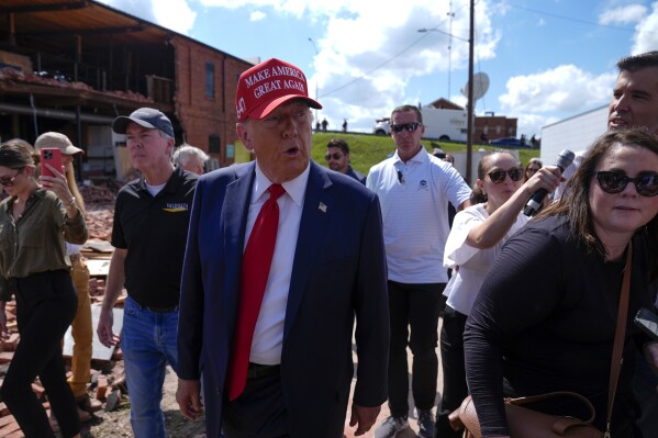 Republican presidential nominee former President Donald Trump walks outside the Chez What furniture store as he visits Valdosta, Ga., a town impacted by Hurricane Helene, Monday, Sept. 30, 2024. (AP Photo/Evan Vucci)