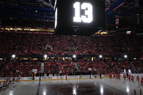 The number 13, worn by former Calgary Flames player Johnny Gaudreau, is displayed during a memorial ceremony prior to an NHL hockey game against the Philadelphia Flyers in Calgary, Alberta, Saturday, Oct. 12, 2024. (Jeff McIntosh/The Canadian Press via AP)