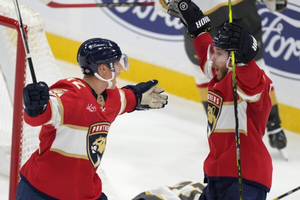 Florida Panthers defenseman Gustav Forsling, left, celebrates with center Sam Bennett after Forsling scored during an overtime period of an NHL hockey game, Saturday, Oct. 19, 2024, in Sunrise, Fla. (AP Photo/Wilfredo Lee)