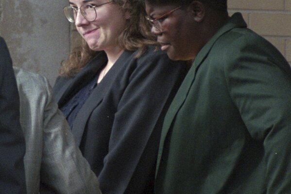 Convicted murderer Susan Smith is escorted from the Union County Courthouse on July 28, 1995 by corrections officer Felicia Mungo after being sentenced to life in prison for the drowning deaths of her two boys last October. (AP Photo/Lou Krasky)