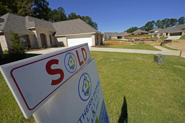 FILE - A "SOLD" sign decorates the lawn of a new house in Pearl, Miss., Sept. 23, 2021. U.S. home loan applications are at the lowest level in decades, the latest evidence that rising mortgage rates and home prices are shutting out many aspiring homeowners. (AP Photo/Rogelio V. Solis, File)