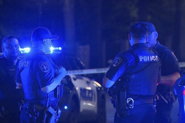 This image provided by WBMA shows police working on the scene of a shooting in Birmingham, Ala., Sunday, Sept. 22, 2024. (Bill Castle/WBMA via AP)