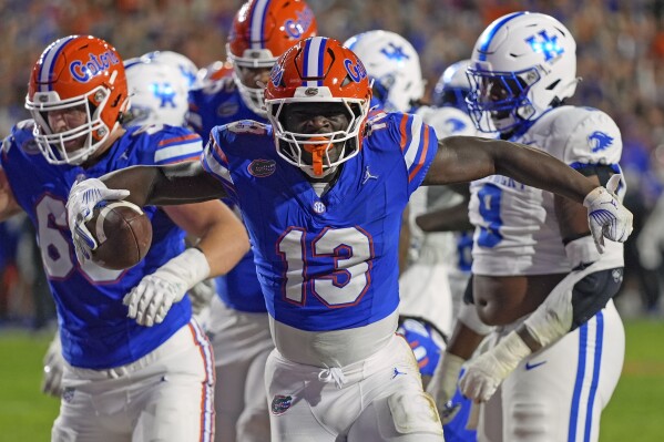 Florida running back Jadan Baugh (13) celebrates after a touchdown run against Kentucky during the first half of an NCAA college football game, Saturday, Oct. 19, 2024, in Gainesville, Fla. (AP Photo/John Raoux)