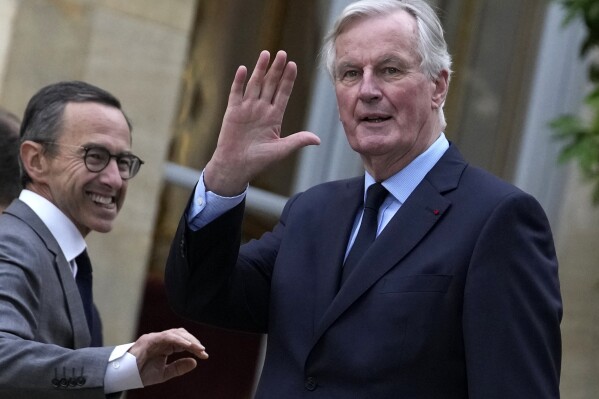 FILE - French Interior Minister Bruno Retailleau, right, and French Prime Minister Michel Barnier speak during a family picture in Paris, Friday, Sept. 27, 2024. (AP Photo/Christophe Ena, File)