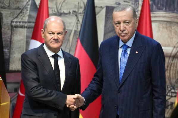 Turkey's President Recep Tayyip Erdogan, right, shakes hands with Germany's Chancellor Olaf Scholz, following a press conference in Istanbul, Turkey, Saturday, Oct. 19, 2024. (AP Photo/Khalil Hamra)