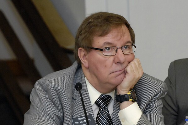 FILE - North Dakota Sen. Ray Holmberg listens during a joint House and Senate Appropriations Committee meeting at the state Capitol, Jan. 7, 2009, in Bismarck, N.D. On Thursday, Oct. 26, 2023, the former, longtime North Dakota lawmaker was indicted on federal charges alleging he traveled to Prague for sex with a minor and also received child pornography. He is charged with two counts: travel with intent to engage in illicit sexual activity, and receipt and attempted receipt of child pornography. (AP Photo/Will Kincaid, File)