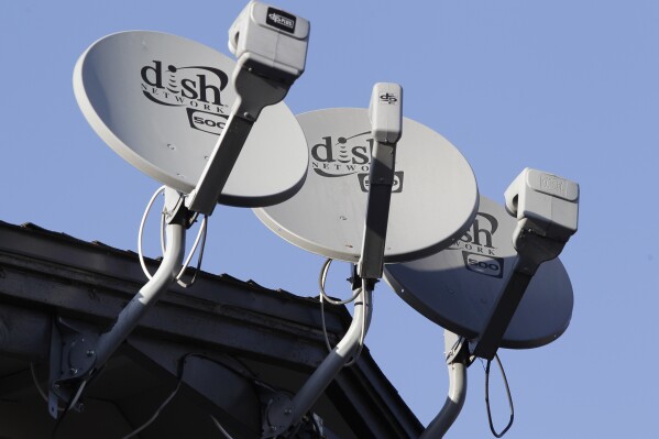 FILE - In this Feb. 23, 2011, file photo, Dish Network satellite dishes are shown at an apartment complex in Palo Alto, Calif. (AP Photo/Paul Sakuma, File)