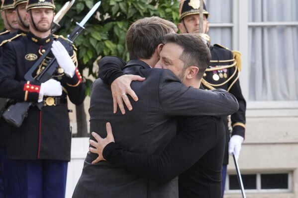 French President Emmanuel Macron, left, greets his Ukrainian counterpart Volodymyr Zelenskyy before a meeting at the Elysee Palace, in Paris, Thursday, Oct. 10, 2024. (AP Photo/Michel Euler)