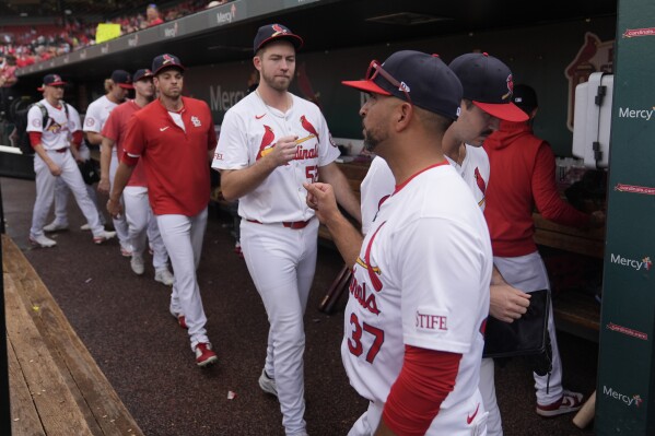 St. Louis Cardinals manager Oliver Marmol (37) fist bumps relief pitcher Matthew Liberatore as they head for the clubhouse following a baseball game against the Cleveland Guardians, the Cardinals final home game of the season, Sunday, Sept. 22, 2024, in St. Louis. (AP Photo/Jeff Roberson)