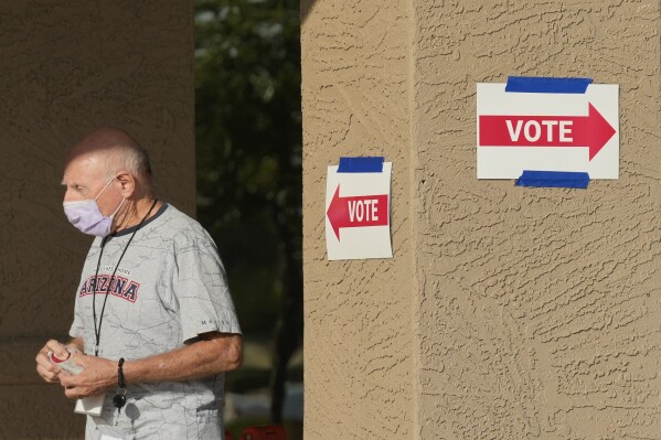 A precinct worker walks outside a voting location during the state's primary election, Tuesday, July 30, 2024, in Sun City West, Ariz. (AP Photo/Ross D. Franklin)