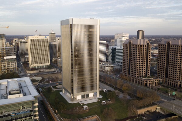 FILE - The Federal Reserve building, center, rises high over the skyline of Richmond, Va., on Dec. 4, 2017. (AP Photo/Steve Helber, File)