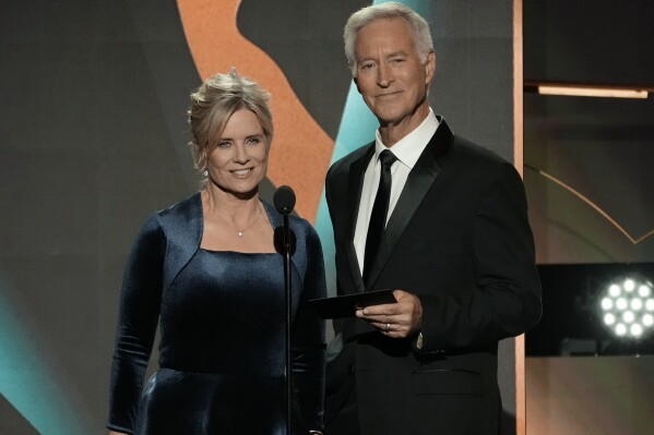 FILE - Mary Beth Evans, left, and Drake Hogestyn present the award for outstanding daytime talk series host during the 50th Daytime Emmy Awards on Friday, Dec. 15, 2023, in Los Angeles. Hogestyn, who played John Black for nearly four decades, has died from pancreatic cancer at age 70. (AP Photo/Chris Pizzello, File)