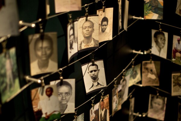 FILE - Family photographs of some of those who died hang in a display in the Kigali Genocide Memorial Centre in Kigali, Rwanda, April 5, 2014. (AP Photo/Ben Curtis, File)