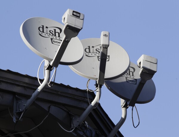 FILE - In this Feb. 23, 2011, file photo, Dish Network satellite dishes are shown at an apartment complex in Palo Alto, Calif. (AP Photo/Paul Sakuma, File)