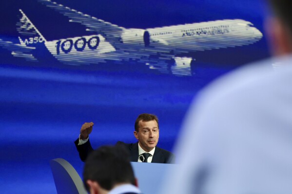 FILE - Airbus CEO Guillaume Faury presents the European aerospace giant full year results, Feb. 15, 2024 in Blagnac, near Toulouse, southwestern France. In the latest round of their decades-long battle for dominance in commercial aircraft, Europe's Airbus has established a clear sales lead over Boeing as the American company deals with the fallout from manufacturing troubles and ongoing safety concerns. (AP Photo/Fred Scheiber, File)