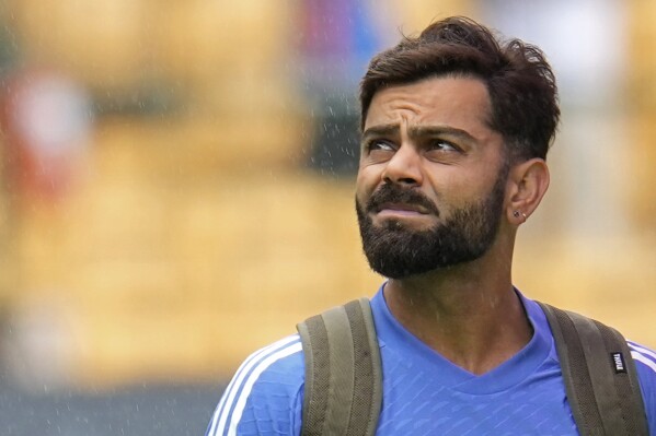 India's Virat Kohli looks skywards as he walks across the field after rains delayed the start of the day one of the first cricket test match between India and New Zealand at the M.Chinnaswamy Stadium, in Bengaluru, India, Wednesday, Oct. 16, 2024. (AP Photo/Aijaz Rahi)