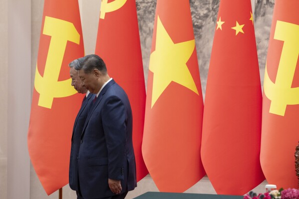 Chinese President Xi Jinping, right, and Vietnam's President To Lam walk out of a signing ceremony at the Great Hall of the People in Beijing Monday, Aug. 19, 2024. (Andres Martinez Casares/Pool Photo via AP)