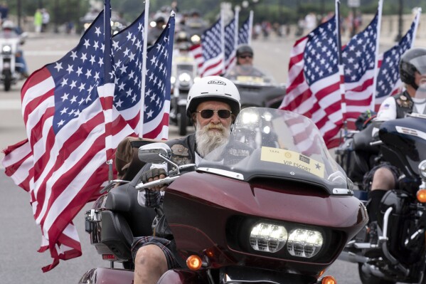 FILE - Participants in the "Rolling to Remember" motorcycle rally ride past Arlington Memorial Bridge during the annual motorcycle parade, ahead of Memorial Day, in Washington, Sunday, May 28, 2023. (AP Photo/Jose Luis Magana, File)