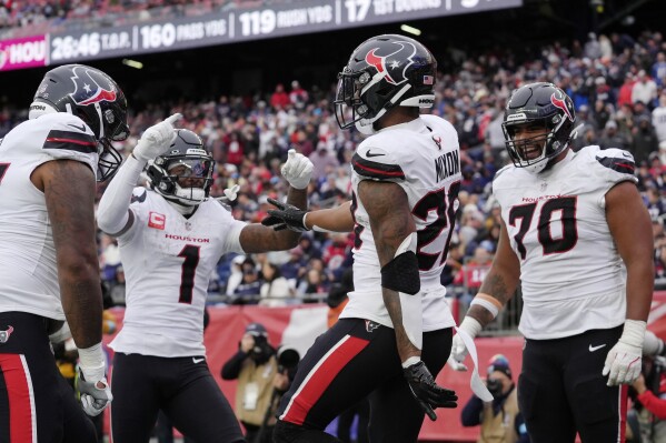 Houston Texans running back Joe Mixon (28) celebrates after his touchdown with wide receiver Stefon Diggs (1) and center Juice Scruggs (70) during the second half of an NFL football game against the New England Patriots, Sunday, Oct. 13, 2024, in Foxborough, Mass. (AP Photo/Steven Senne)