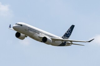 FILE - An Airbus A220 lands at Toulouse-Blagnac airport, July 10, 2018, in southwestern France. Federal regulators are investigating how parts made with counterfeit titanium wound up in some Boeing and Airbus passenger jets that were built in recent years. Boeing and Airbus said Friday, June 14, 2024, that planes containing the parts are safe to fly. (AP Photo/Frederic Scheiber, File)