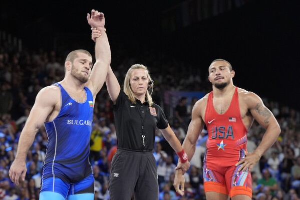 Bulgaria's Magomed Ramazanov celebrates after defeating Aaron Marquel Brooks, of the United State, in their men's freestyle 86kg semifinal wrestling match, at Champ-de-Mars Arena, during the 2024 Summer Olympics, Thursday, Aug. 8, 2024, in Paris, France. (AP Photo/Eugene Hoshiko)