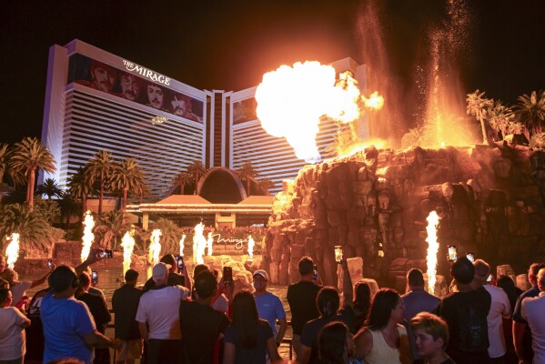 People watch the final scheduled volcano show during the final night of operations and gaming at The Mirage on Tuesday, July 16, 2024, in Las Vegas. (Chase Stevens/Las Vegas Review-Journal via AP)