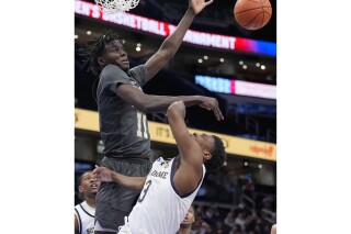 FILE - Notre Dame guard Markus Burton (3) has his shot blocked by Georgia Tech forward Baye Ndongo (11) during the second half of the Atlantic Coast Conference NCAA college basketball tournament, Tuesday, March 12, 2024, in Washington. (AP Photo/Alex Brandon, File)