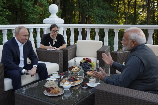 Russian President Vladimir Putin, left, speaks with Indian Prime Minister Narendra Modi during an informal meeting at Novo-Ogaryovo residence, outside Moscow, Russia, Monday, July 8, 2024. (Gavriil Grigorov, Sputnik, Kremlin Pool Photo via AP)