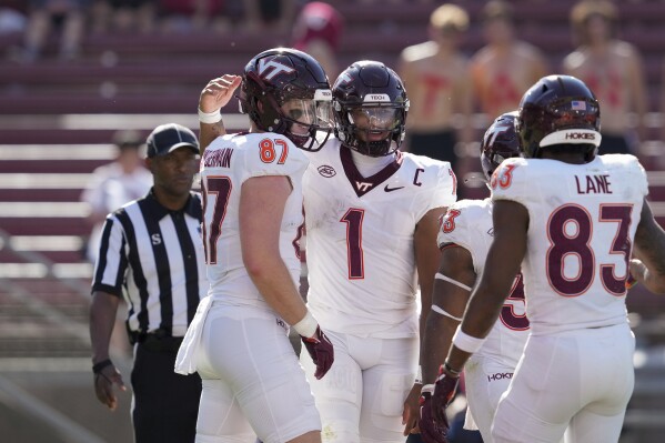 Virginia Tech quarterback Kyron Drones (1) celebrates with tight end Harrison Saint Germain, left, after scoring a rushing touchdown during the second half of an NCAA college football game against Stanford, Saturday, Oct. 5, 2024, in Stanford, Calif. (AP Photo/Godofredo A. Vásquez)