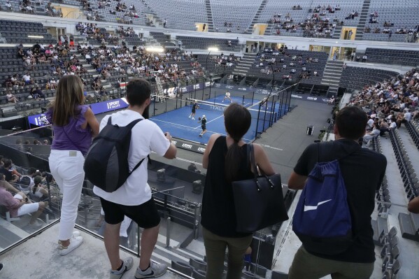 Spectators watch the match between Spaniards Juan Lebron, Alejandro Galan and Antonio Fernandez, Pablo Corona at the Italy Major Premier Padel tournament in Rome, Wednesday, July 12, 2023. A successful debut at the European Games with matches played before enthusiastic crowds in Krakow's central square last month. Record prize money of nearly $1 million at this week's tournament in Rome. Padel, the fastest growing racket sport in the world among amateurs, is also making big strides at the professional level. (AP Photo/Gregorio Borgia)