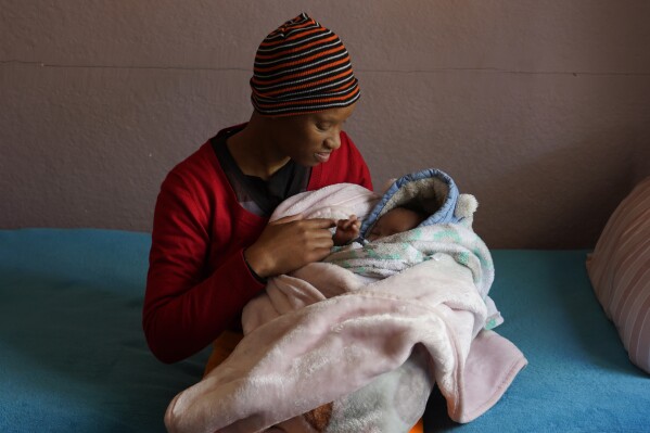 Mapule Radebe holds her baby Minehle at Nkosi's Haven, a home that assists women with HIV, in Johannesburg, Monday, Aug. 5, 2024. (AP Photo/Denis Farrell)